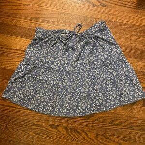Blue Brandy Melville skirt with white flower design.